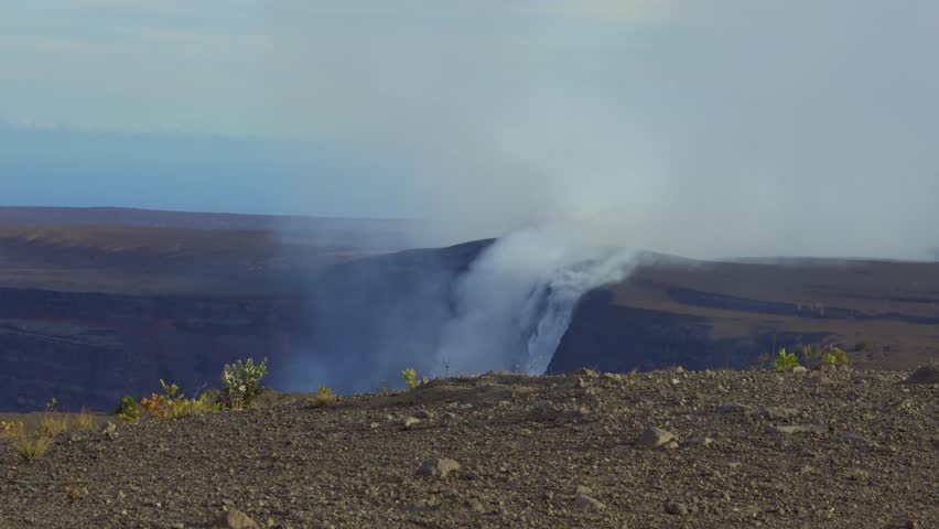 Active Kilauea volcano caldera emitting smoke and steam from Halemaʻumaʻu crater, Hawaiʻi Volcanoes National Park, Big Island
