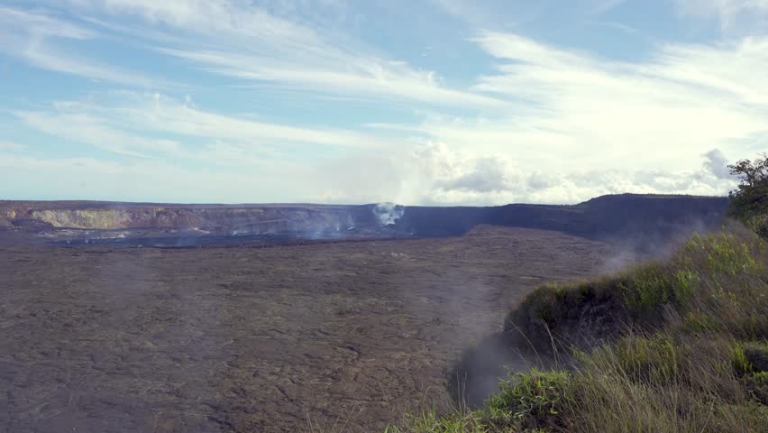 Active Kilauea volcano caldera emitting smoke and steam from Halemaʻumaʻu crater, Hawaiʻi Volcanoes National Park, Big Island