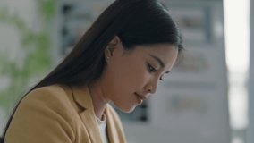 businesswoman at organized desk writing down goals and ideas for company improvement strategy - Powered by Shutterstock - Get 15% off with code: PIKWIZARD15