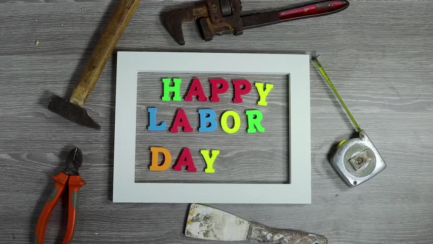 Happy Labor Day Message Decorated With Tools and American Flag on Wood