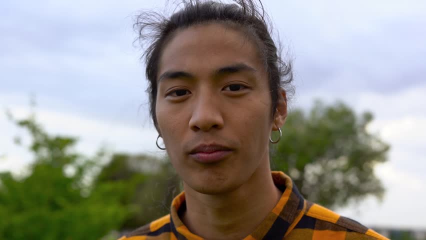  Young indigenous man smiling on camera at city park - Lifestyle and culture concept