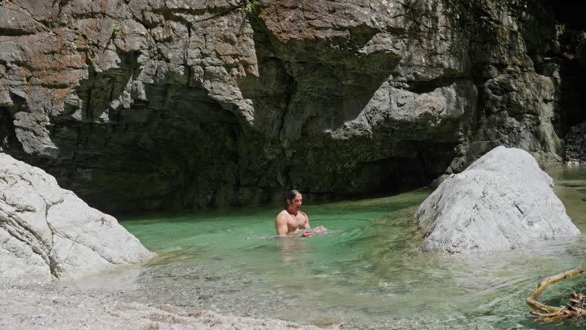 Enjoy a Refreshing and Invigorating Swim in the Serene Natural Pool Nestled Amidst Rocks. Slow motion