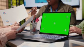 Group of businesswoman looks at isolated mockup on laptop, briefing session meeting in a modern boardroom setting. Corporate reports for presentations and resources analysis. Camera B. - Powered by Shutterstock - Get 15% off with code: PIKWIZARD15