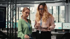 Determined team of professional women assembling to review charts and data projections, illustrating their collaborative mindset to guarantee strategic analysis for measurable success. Camera A. - Powered by Shutterstock - Get 15% off with code: PIKWIZARD15