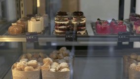 Assorted mini cakes and mousse desserts in a glass display fridge in a modern cafe - Powered by Shutterstock - Get 15% off with code: PIKWIZARD15