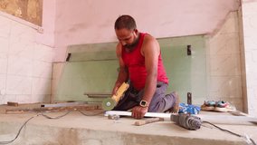 Skilled Laborer Works over Alloy Frame Inside shop, Mason Uses Power Cutter on Ground Level Panel, Fabricator Shapes Aluminum Bar with Precision Tools, Worker strikes metal pipe gently to position it - Powered by Shutterstock - Get 15% off with code: PIKWIZARD15