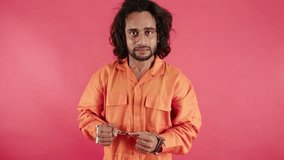 Convict Under Restraints Gnashes Teeth in Rage, Furious Prisoner Stand Handcuffed with Wild Gaze, Detainee Have Long Hair Glares Aggressively, Lawbreaker Show Anger By Jail Jumpsuit, Criminal Arrested - Powered by Shutterstock - Get 15% off with code: PIKWIZARD15