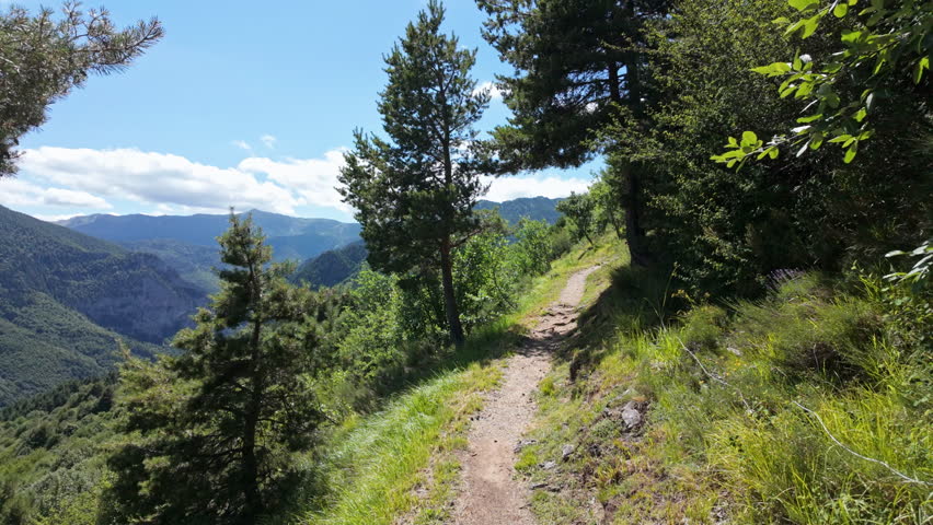 Peaceful mountain trail under blue sky, perfect for nature exploration
