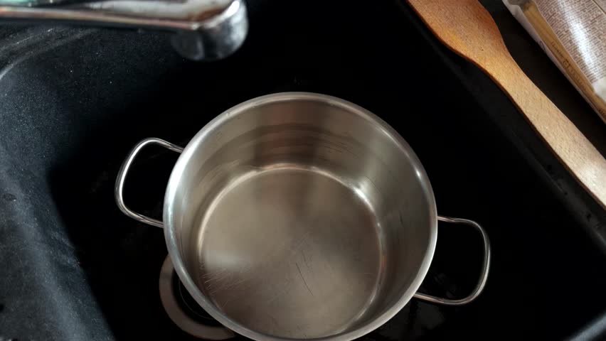 Water Pouring Into Metal Pot. Kitchen Chores And Routine. Domestic Kitchen Environment. Meal Prep. Filling A Pot With Water In Kitchen Sink. Cooking Preparation Process. Cooking For A Healthy Meal