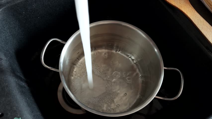Water Pouring Into Metal Pot. Kitchen Chores And Routine. Domestic Kitchen Environment. Meal Prep. Filling A Pot With Water In Kitchen Sink. Cooking Preparation Process. Cooking For A Healthy Meal
