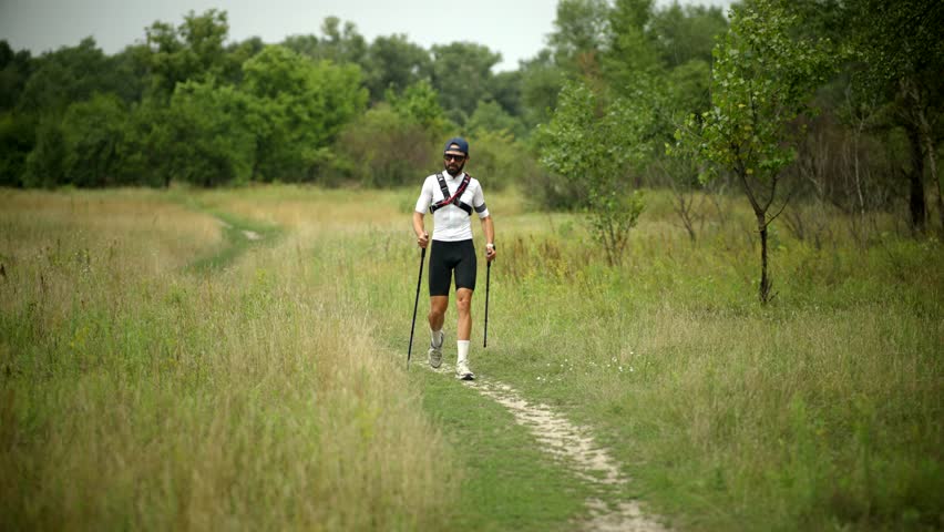 Hiking Exercise Trail Walk. Nordic Walking Trekking Poles. Summer Hiking Day Staying Fit. Trail Running Cardio Exercise. Runner Sportswear And Equipment. Endurance Training. Trail Fitness Running