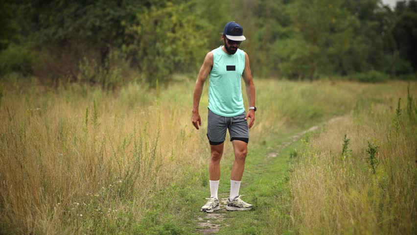 Runner Doing Quad Stretch Warming Up. Trail Runner Stretching. Outdoor Fitness Workout. Leg Stretch. Warmup Before Workout Run. Running Exercise. Fitness Sport Activity. Runner Flexibility Stretching. Runner Exercising