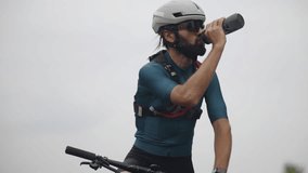 Cyclist Drinking Water Bottle. Taking Break During Ride. Hydration In Cycling. Healthy Habits And Fitness. Fitness And Endurance Sport Cycling. Mountain Bike Rider. Cyclist Cardio Exercise Hydrating  - Powered by Shutterstock - Get 15% off with code: PIKWIZARD15