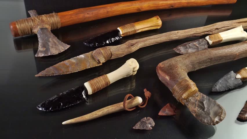 Stone Age Tools on black Background - Stone age Knives, Axe and Arrows
