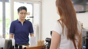 Small business entrepreneur barista coffee shop cafe restaurant. Customer tap credit card on card swipe machine making online banking payment buy coffee at cashier counter. Cashless payment technology - Powered by Shutterstock - Get 15% off with code: PIKWIZARD15