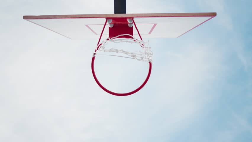 Epic view under basket for streetball against sky, static shot outdoors. Streetball and basketball court, hobby and sport activity for stay healthy and entertainment, move to dream, be champion