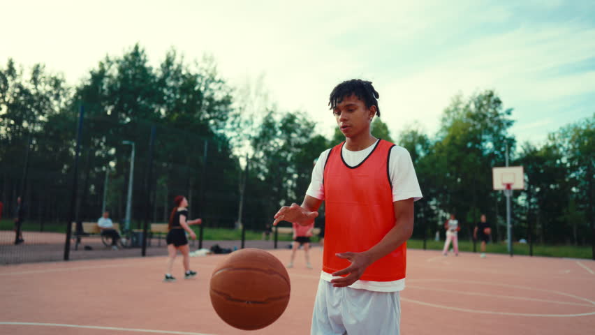 African american teens playing streetball in outdoor court, sport for juniors. Active pastime in weekend, young people spending pastime on basketball court, healthy lifestyle for be strong and active