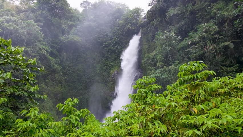 Scenic view of Togarau waterfall with heavy fast flowing water in Wakunai mountainous region of central Bougainville Island, Papua New Guinea