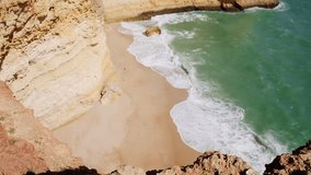 Waves Crashing On The Shores With Red Sandstone Cliffs In Faro District, Algarve, Portugal. High Angle Shot - Powered by Shutterstock - Get 15% off with code: PIKWIZARD15