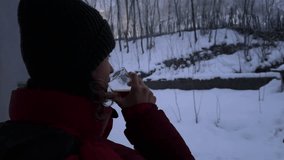 Woman drink herbal tea coffee winter landscape forest frozen mountain countryside Iran lifestyle relaxation hiking viewpoint snowfall snow climate Hyrcanian peaceful adventure outdoor activity nature - Powered by Shutterstock - Get 15% off with code: PIKWIZARD15