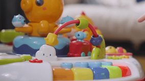 Two kids playing with colorful plastic toy featuring musical keyboard and moving train. Older child engages the younger. Close-up scene. - Powered by Shutterstock - Get 15% off with code: PIKWIZARD15