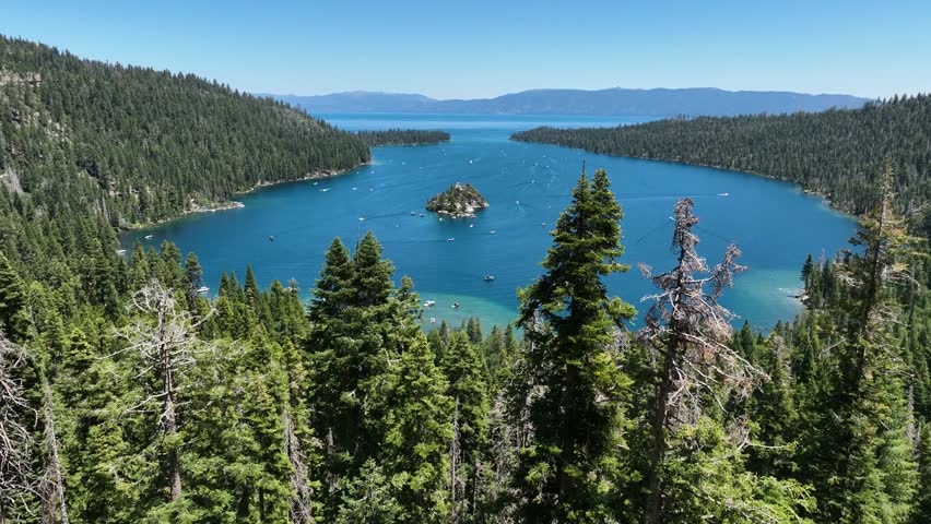 Aerial view over trees toward the Emerald bay, sunny, summer day in Tahoe, USA