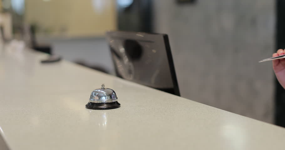 Close up of businessman hands getting room key at hotel reception. Hotel service.