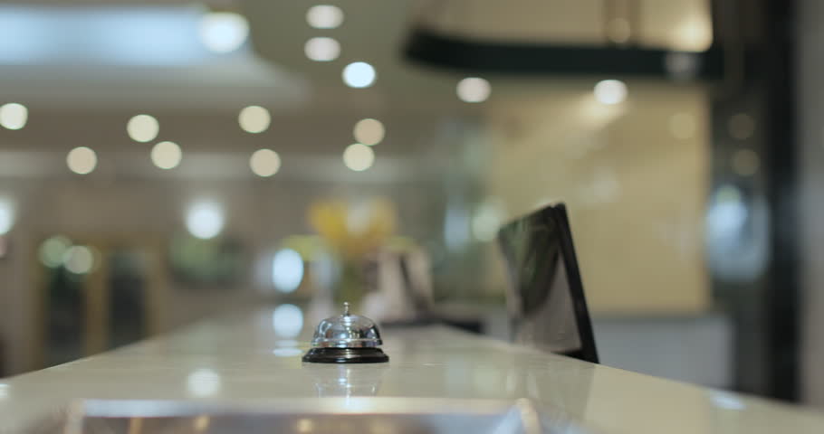 Close up of businesswoman hands getting room key at hotel reception. Hotel service.