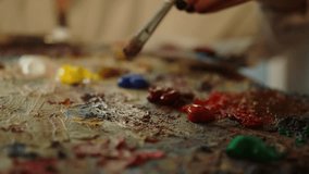 Close up portrait female artist hands with art brush and color paints on palette. Painter at studio mixing color paints, preparing for painting picture. woman girl. brush. paintbrush. creative hobby - Powered by Shutterstock - Get 15% off with code: PIKWIZARD15