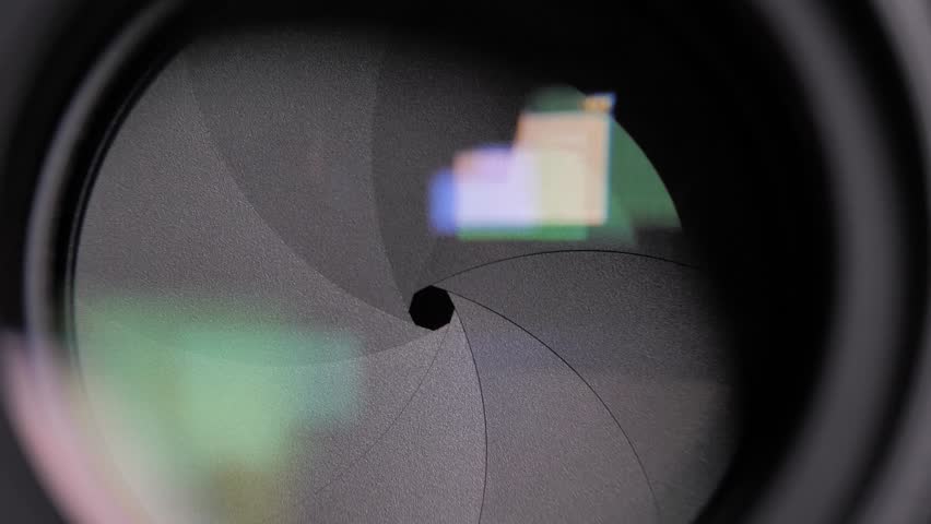 Shot of Diaphragm blades of fixed camera lens opening and closing aperture. Closing and opening Aperture of film camera. Camera lens aperture close up. photo camera HD. DSLR shutter. photography