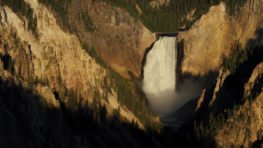 Artist Point in Yellowstone National Park lower falls at sunrise golden hour.