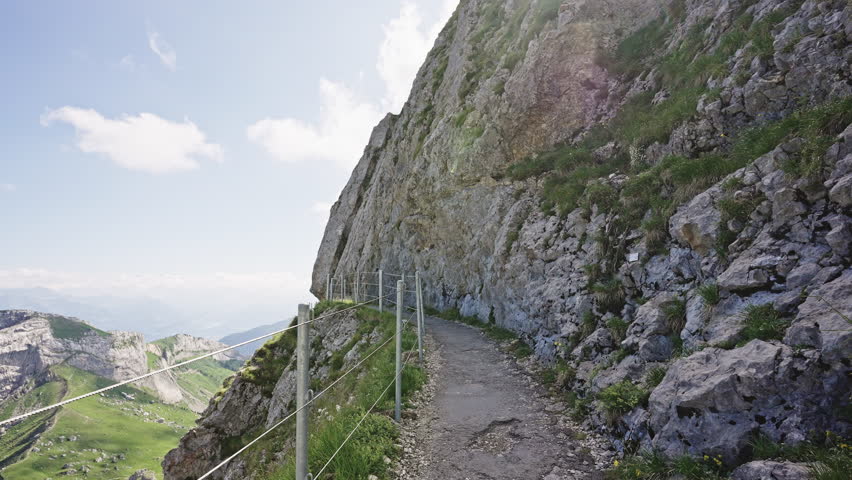 Narrow Hiking Trail on Rocky Cliffside of Mount Pilatus, Switzerland