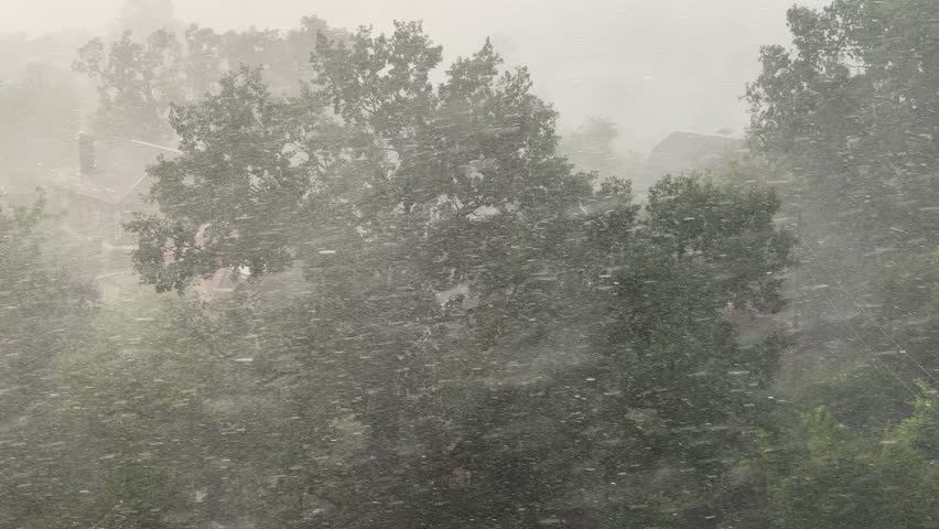 Heavy rain and strong wind in residential area — stormy weather, urban rainfall, extreme weather conditions, intense downpour in city