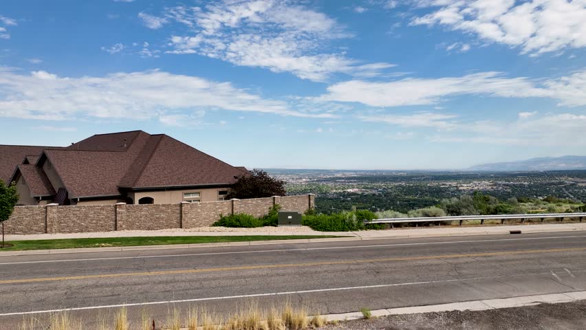 Draper, Utah looking north at the Salt Lake Valley and the sprawling urban suburbs - ascending aerial reveal