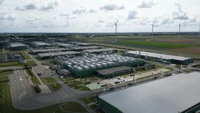 Aerial footage showing a sustainable data center in Eemshaven surrounded by Dutch countryside and wind turbines. Technology and renewable energy in harmony. - Powered by Shutterstock - Get 15% off with code: PIKWIZARD15