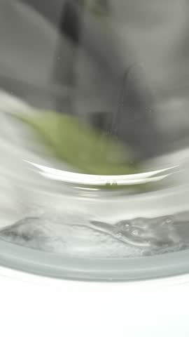 Washing machine washes white clothing and sheets. Cylinder spinning. Nobody. Vertical footage