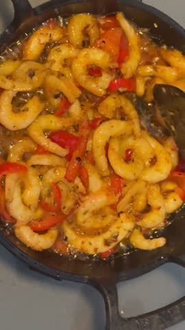 Deliciously cooked shrimp tossed with vibrant red peppers in a cast-iron skillet, showcasing the flavors and colors of a delightful seafood dish ready to be served, Marmara Island, tc01