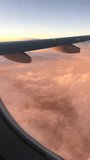 Airplane wing above pink clouds at sunset, view from passenger window
 - Powered by Shutterstock - Get 15% off with code: PIKWIZARD15