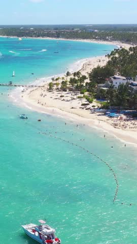 Tropical coastline with resorts, palm trees and caribbean sea. Travel destinations. Dominican Republic. Aerial view