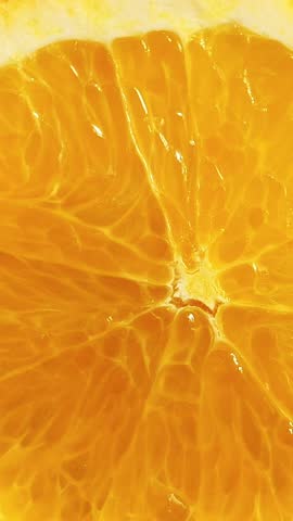 Orange slices closeup. food summer background. top view. Rotate. Vertical footage