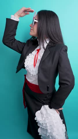 Chilean woman wearing traditional huasa clothing dances with chilean flag glasses