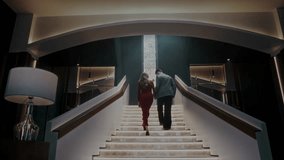 Smartly dressed man and woman walk together up the stairs to the terrace of an upscale restaurant during a romantic date - Powered by Shutterstock - Get 15% off with code: PIKWIZARD15