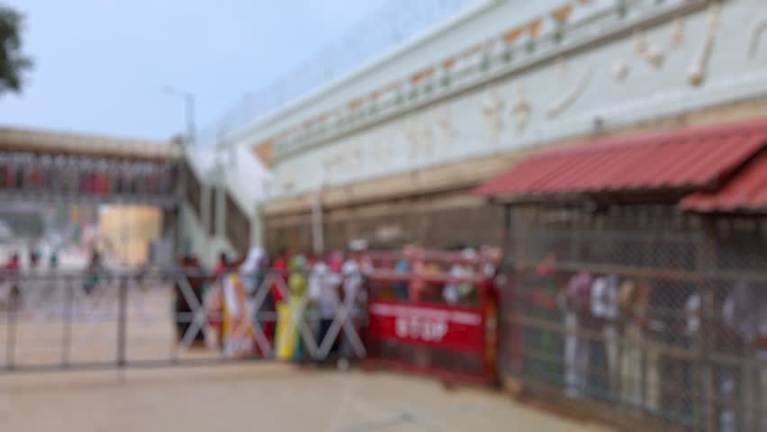 Bokeh view of devotees visit Balaji temple at Tirumala hill. The most visited place of Hindu pilgrimage. Sri Venkateswara Swamy Vaari Temple, Tirumala, Tirupati, India. Blurred background footage.