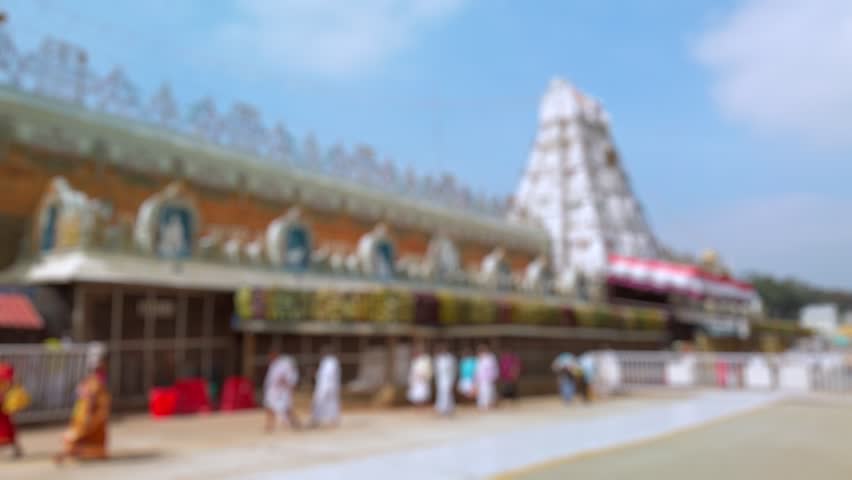 Bokeh view of devotees visit Balaji temple at Tirumala hill. The most visited place of Hindu pilgrimage. Sri Venkateswara Swamy Vaari Temple, Tirumala, Tirupati, India. Blurred background footage.