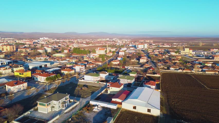 Drone footage showing the main square and residential blocks of a small town.