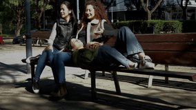 Three friends enjoy a sunny day, sharing laughter and good times in a public park - Powered by Shutterstock - Get 15% off with code: PIKWIZARD15