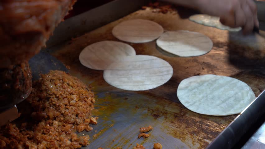 Flour tortilla tacos made in street in Central America. Tacos in food stand in Guatemala