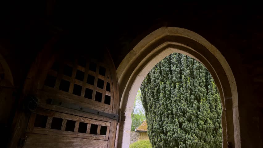 Man enters an historical Kent church, England, clip 3