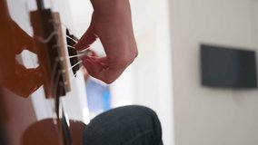 Side view close-up of young woman hand strumming acoustic guitar strings in bright natural light. Mood of musical practice and focused learning at home. Creative, educational, and lifestyle content. - Powered by Shutterstock - Get 15% off with code: PIKWIZARD15