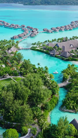 Bora Bora, French Polynesia. Vertical Drone Shot of Luxury Resort With Bungalows Over Water, Lagoon and Island
